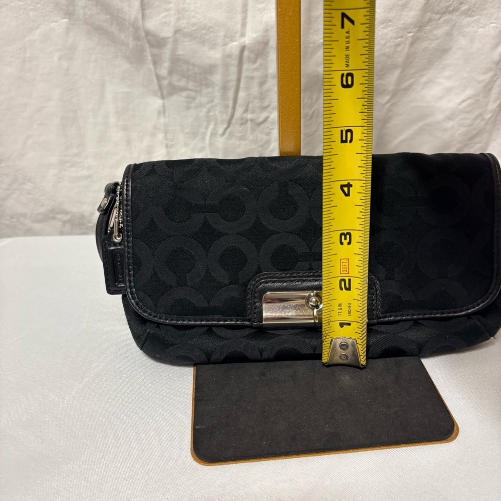 Black clutch wristlet, likely featuring silver-tone hardware - Picture 7 of 7